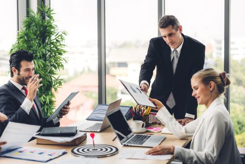 Group of professional business meeting and discussing strategy with new startup project.Creative business people planning and brainstorm with document report in modern workloft.Teamwork concept
